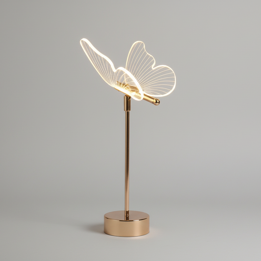 Nordic butterfly table lamp with gold base and glowing acrylic wings